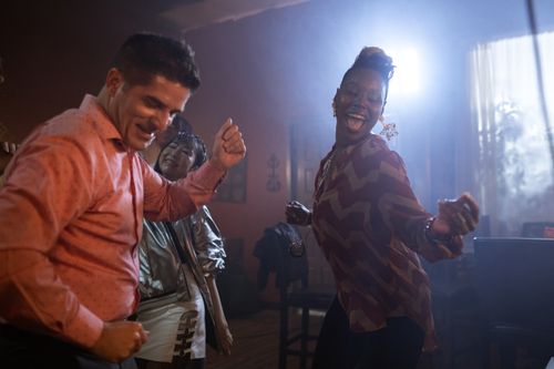 Free A lively group of diverse adults enjoying a vibrant night out dancing. Stock Photo