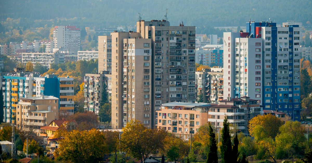 Scenic urban view of Bulgarian high-rises surrounded by colorful autumn leaves.
