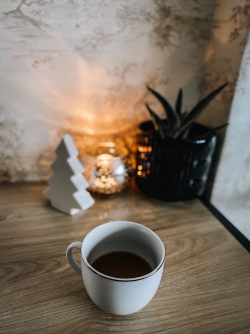 White Ceramic Mug on Brown Wooden Table