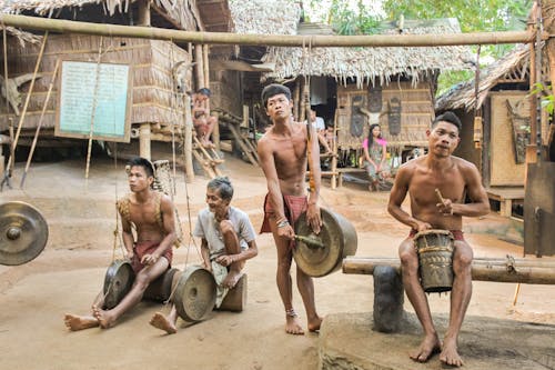 Indigenous People Playing Instruments in Traditional Village