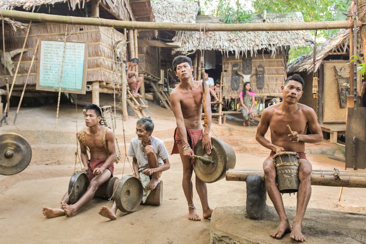 Indigenous People Playing Instruments In Traditional Village