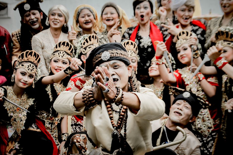 A lively performance showcasing a group of adults in traditional attire, embracing cultural festivities.