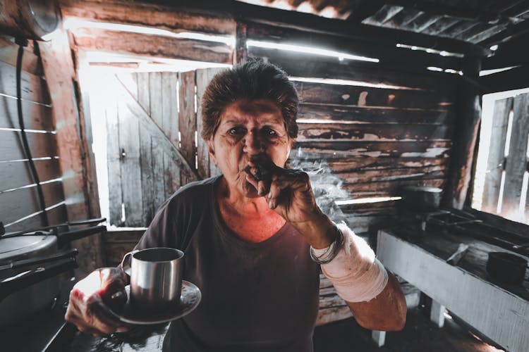 An Elderly Woman Smoking A Cigar