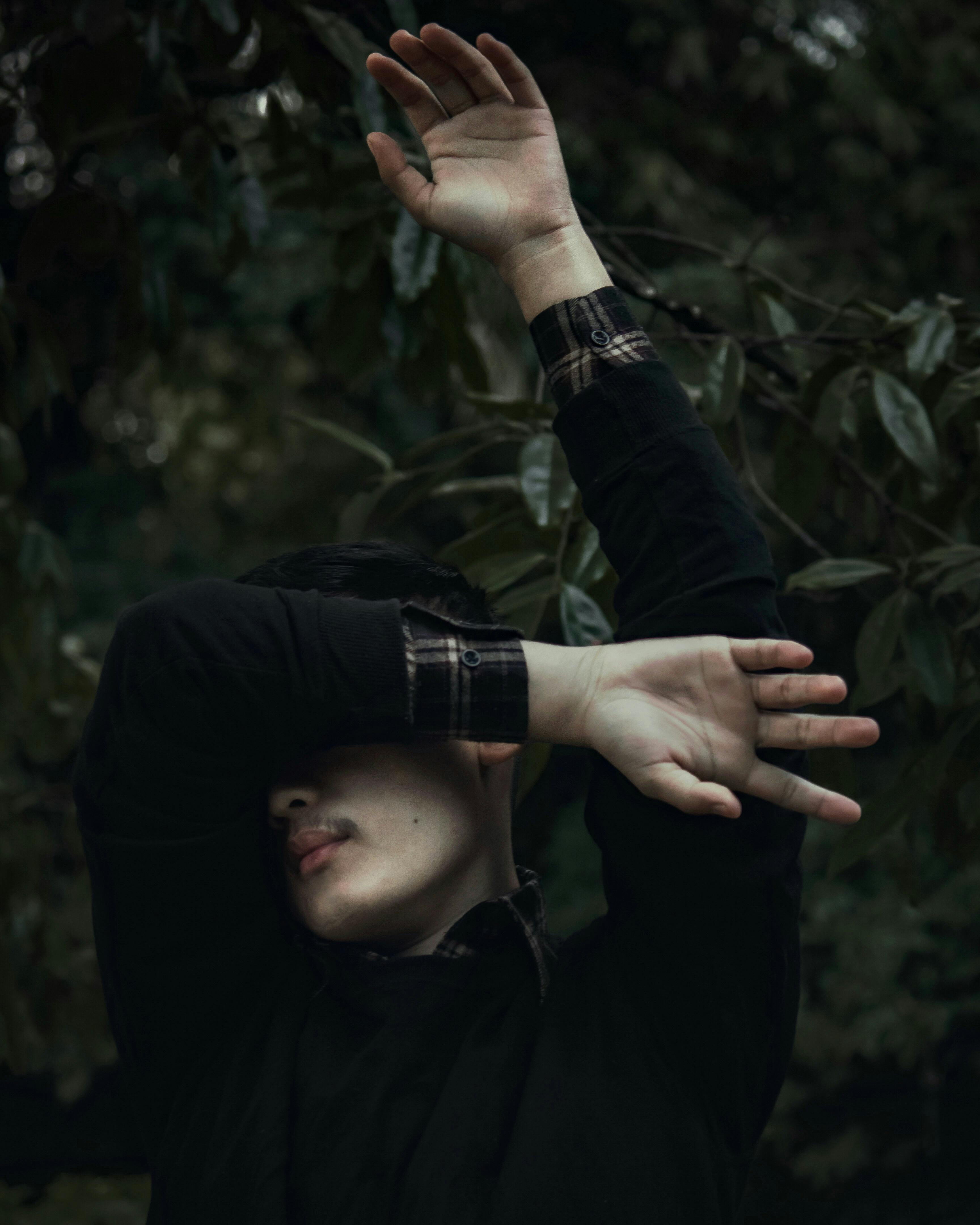 A Man Wearing a Red Sweater Covering His Face with His Hands · Free ...