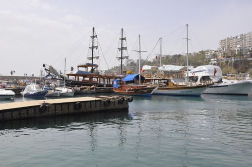 Free Explore the serene Antalya harbor with traditional Turkish boats docked under a clear sky. Stock Photo