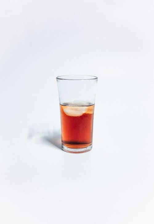 A Clear Drinking Glass With Brown Liquid