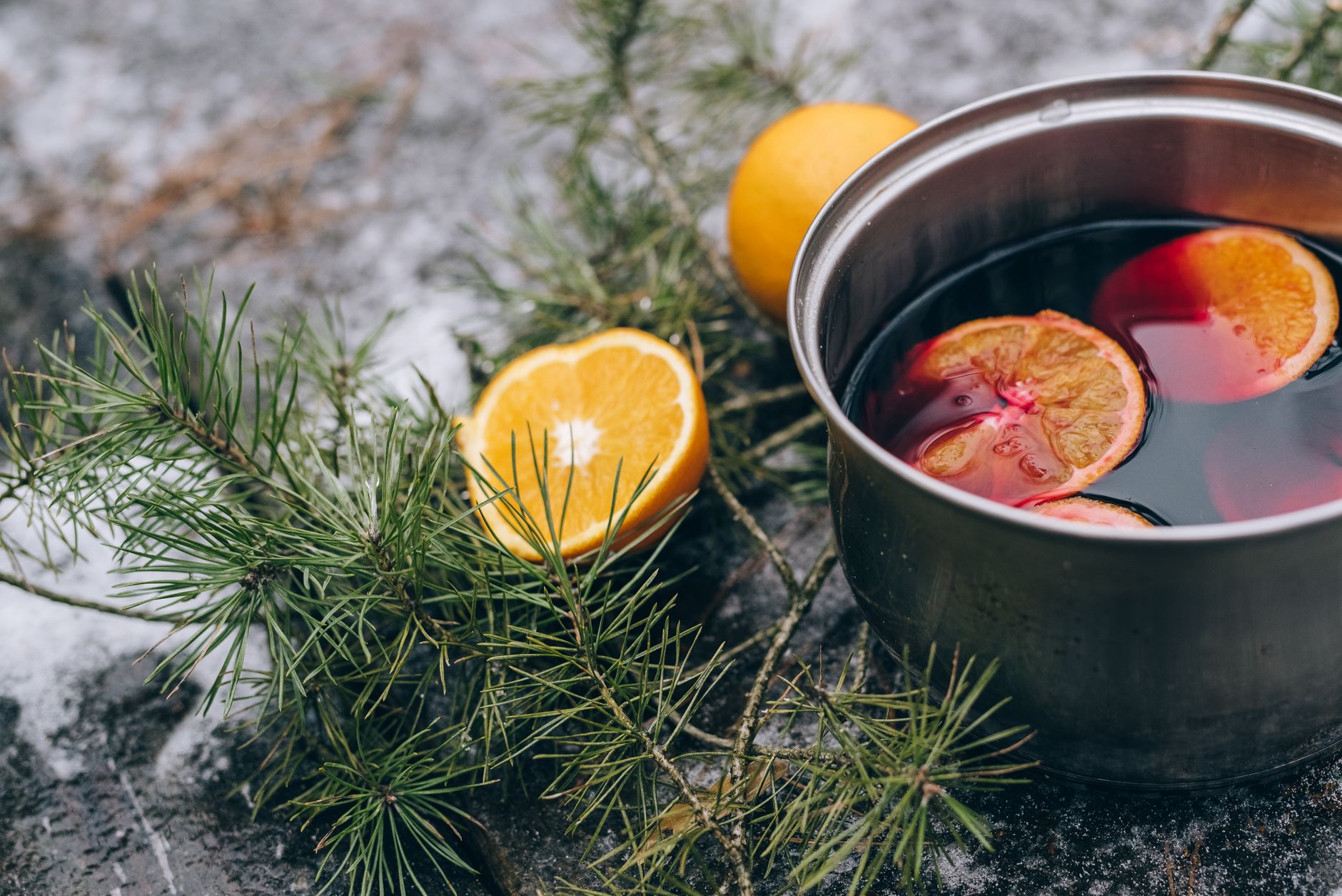 Warm mug of cranberry mulled wine with cinnamon stick