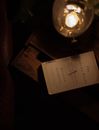 Gas Lamp and Book on Wooden Table