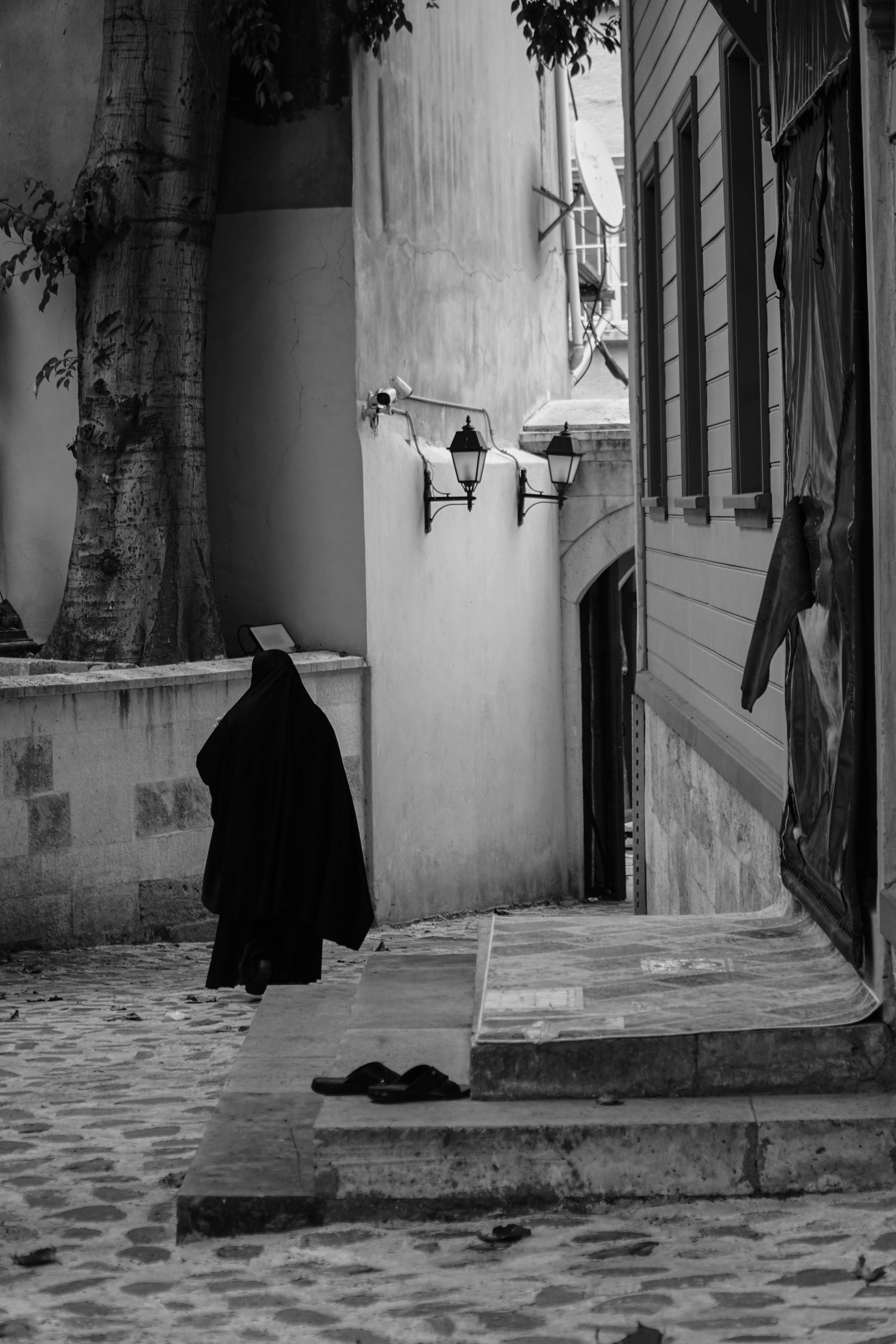 Grayscale Photo of a Person Walking on the Street · Free Stock Photo