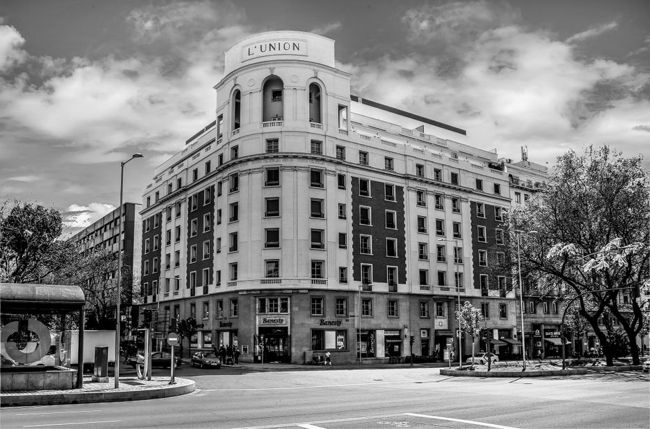 Imagen en blanco y negro de una fachada clásica de un edificio en Madrid, España.