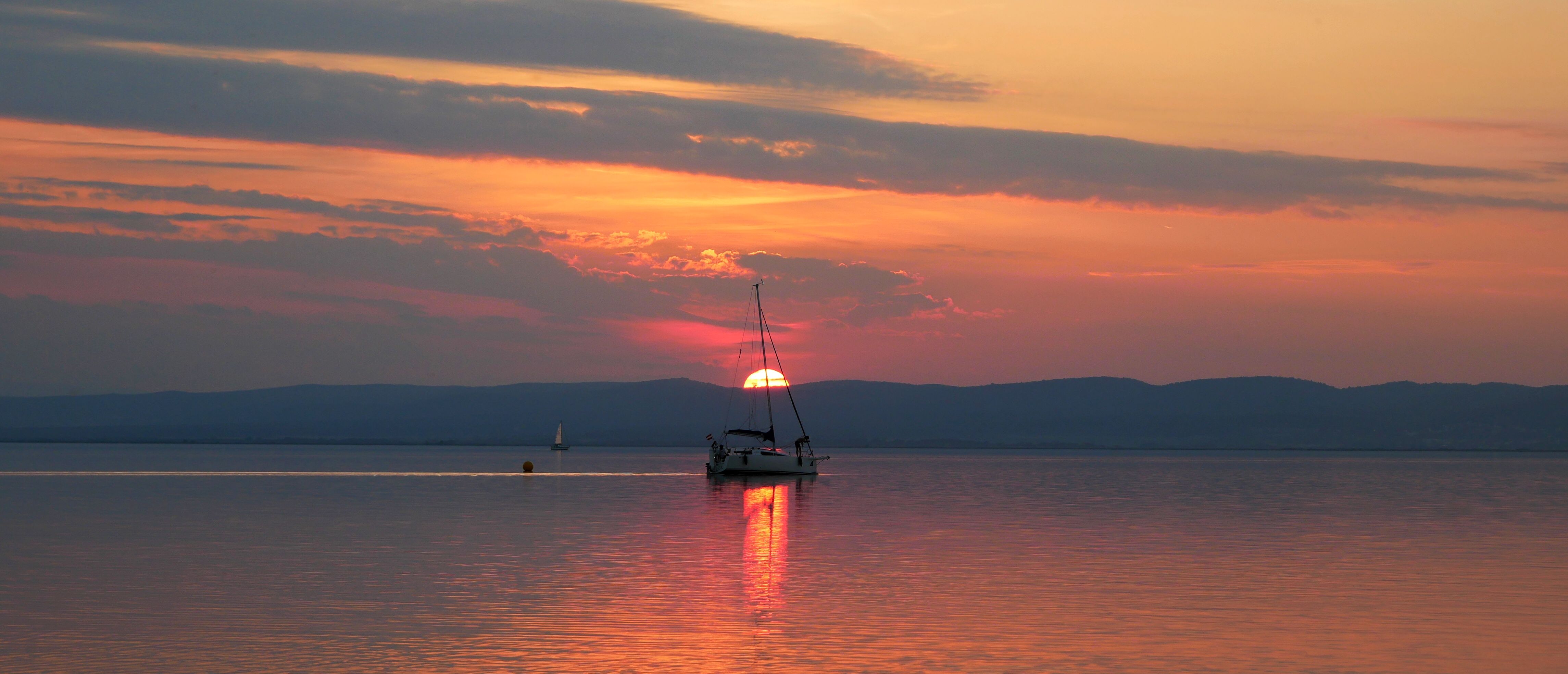 Silhouette of a Boat on Sea during Sunset · Free Stock Photo