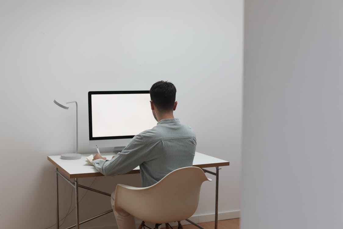 Free Unrecognizable Man Working On Computer At Home Stock Photo