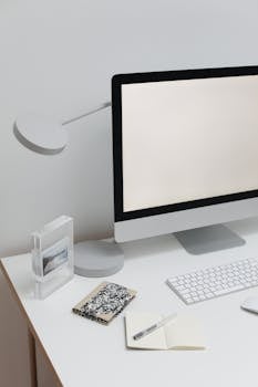 Clean and modern workspace featuring a blank computer screen and minimalist decor.