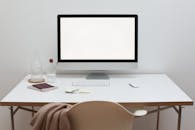 Stylish workspace with computer and simple furniture