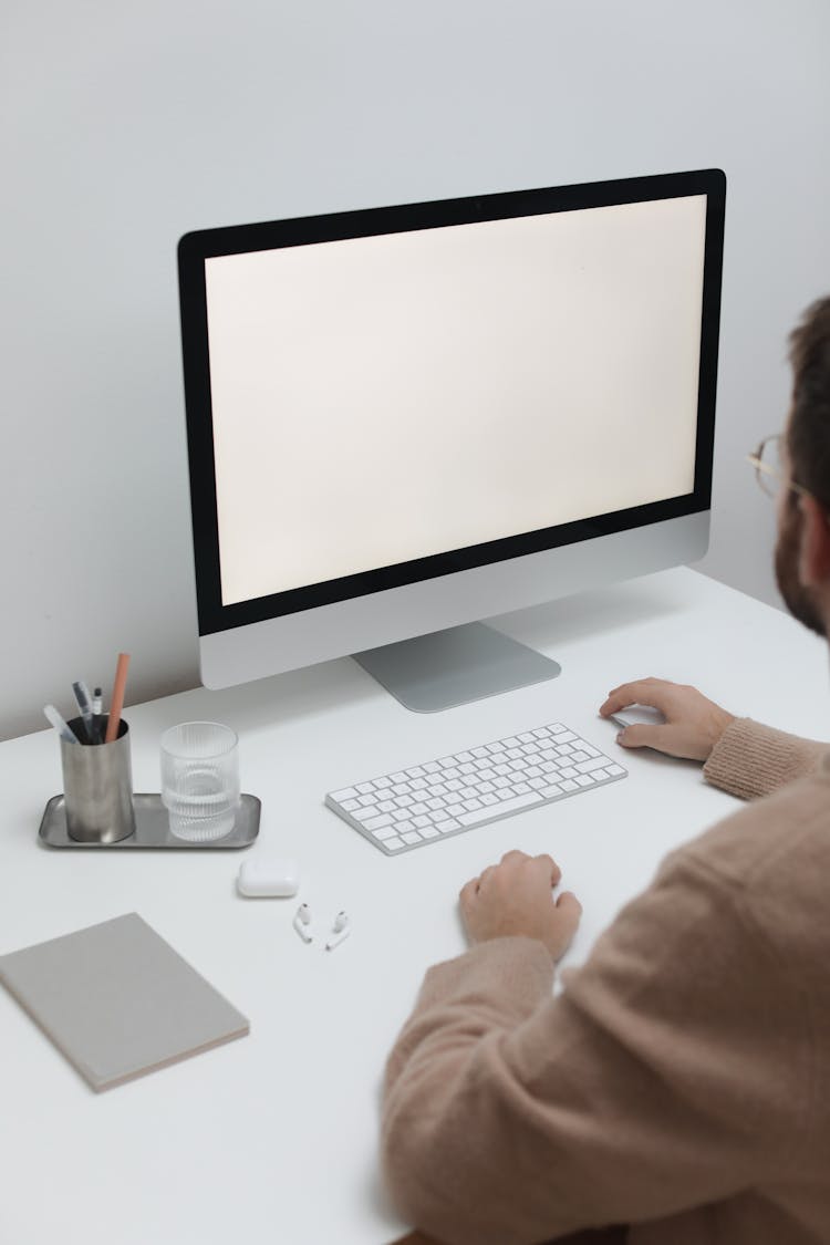 Crop Man Working On Computer In Workplace