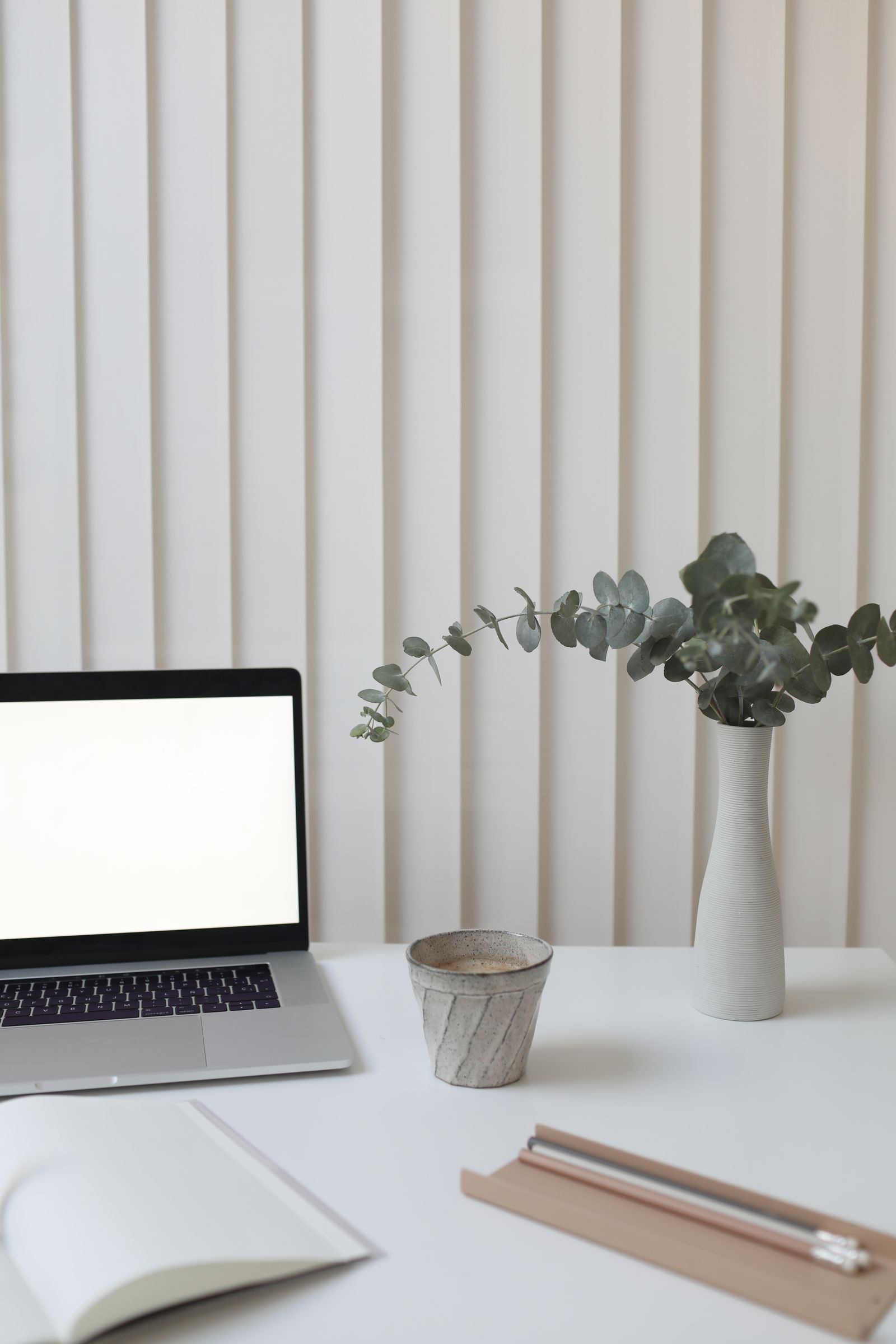 Laptop on a minimalist desk near a window