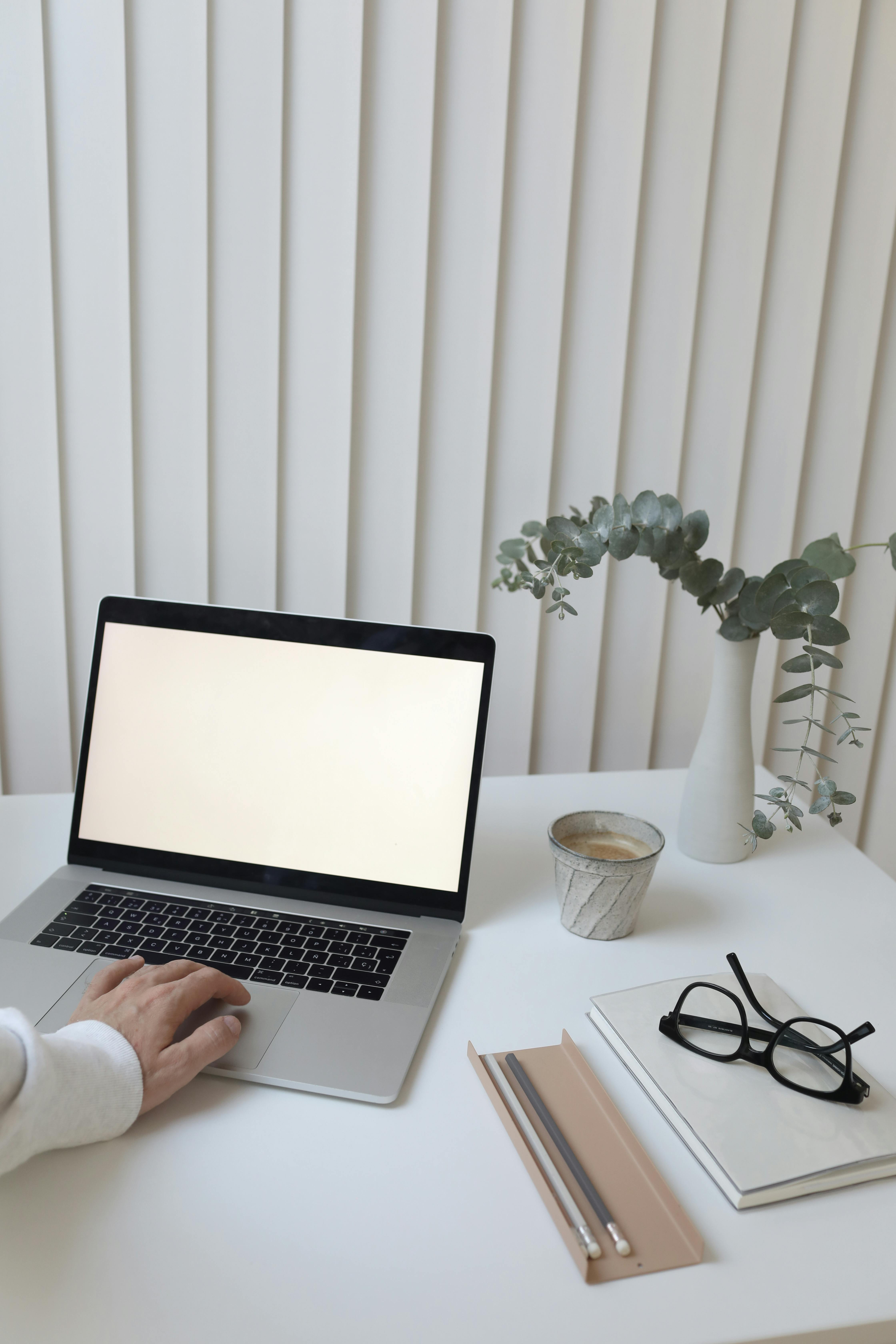 crop person browsing laptop in office