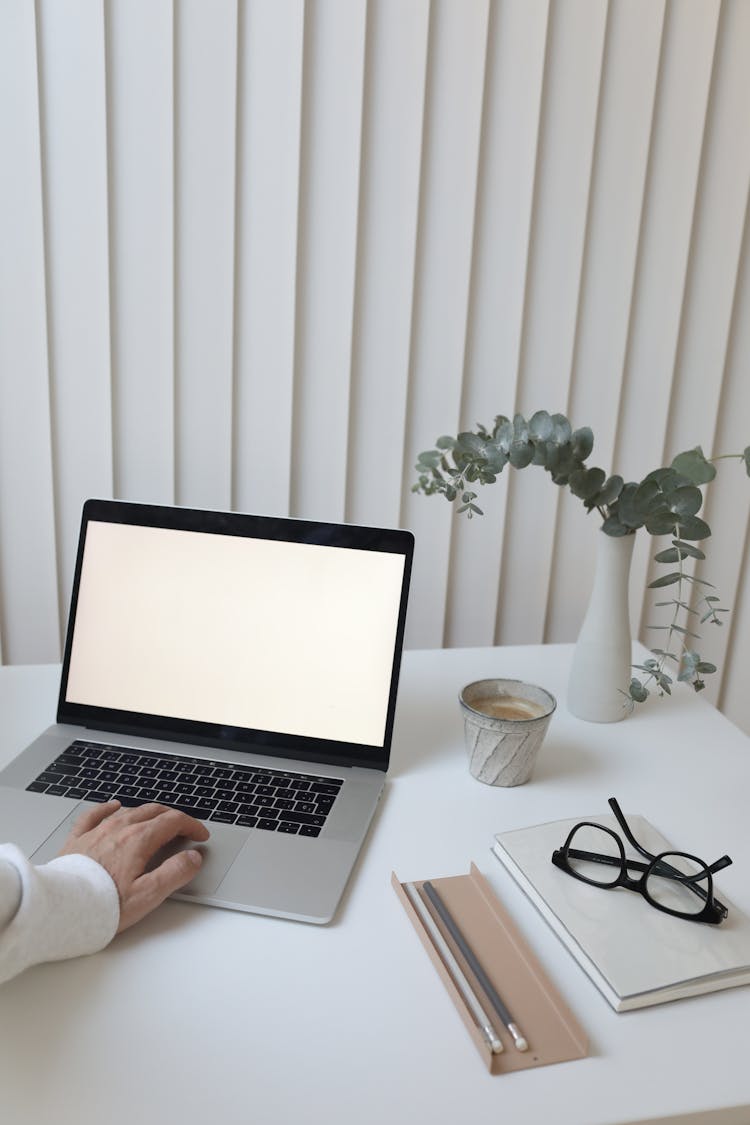 Crop Person Browsing Laptop In Office