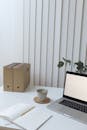 Light workspace with laptop and documents