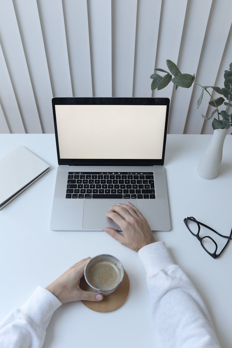 Crop Person With Laptop And Coffee