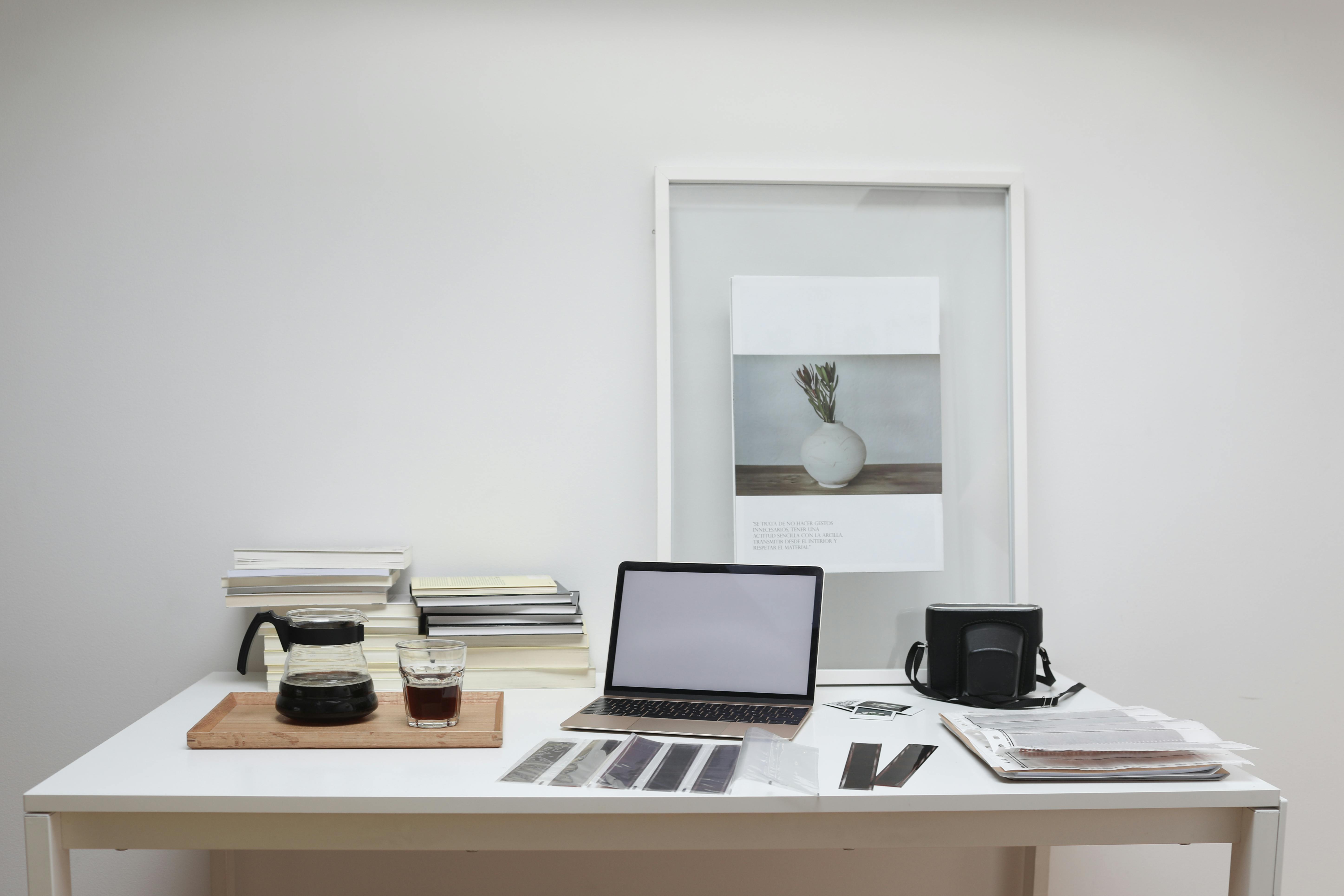 retro negatives and photo camera with reversal film placed on table near laptop