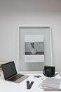 Laptop and vintage camera with negative films placed on desk in office