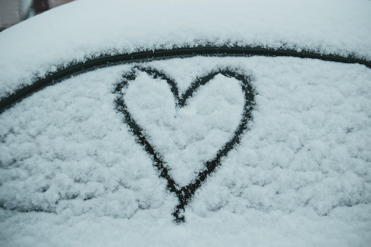 Heart Painted On Snowy Car In Winter