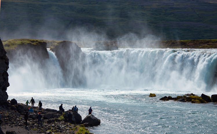 Group Of People At Massive Waterfall 