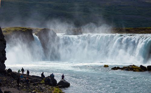 Free Breathtaking view of Godafoss waterfall in Iceland with tourists enjoying the scenic landscape. Stock Photo