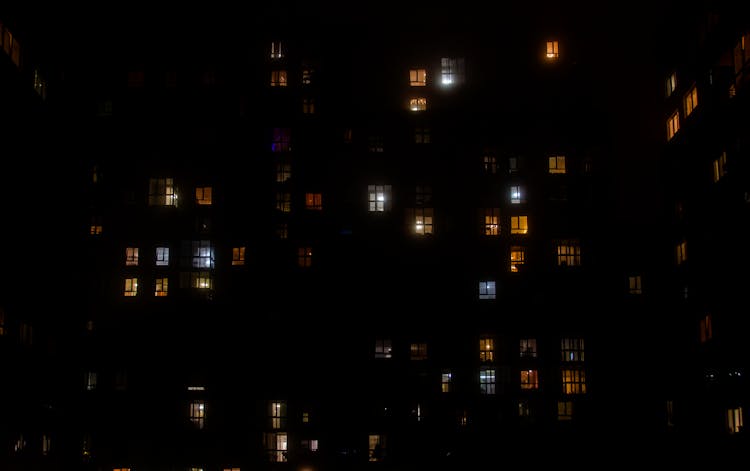 Illuminated Apartments In Residential Building At Night