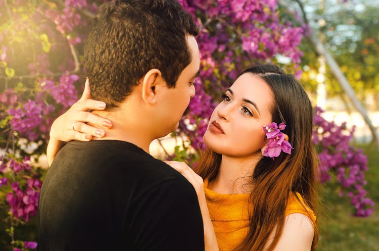 Woman Looking At The Man's Face While Touching His Nape