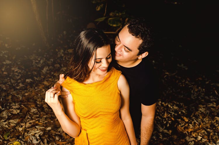 Man Flirting With Woman In Park At Night