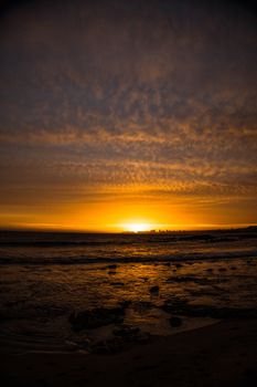Captivating sunset at La Barra Beach, Uruguay, showcasing dramatic skies and a golden seascape.