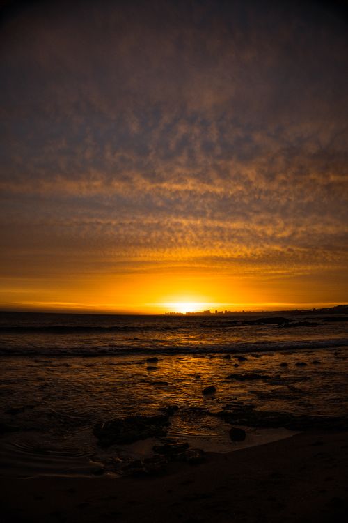Free Captivating sunset at La Barra Beach, Uruguay, showcasing dramatic skies and a golden seascape. Stock Photo