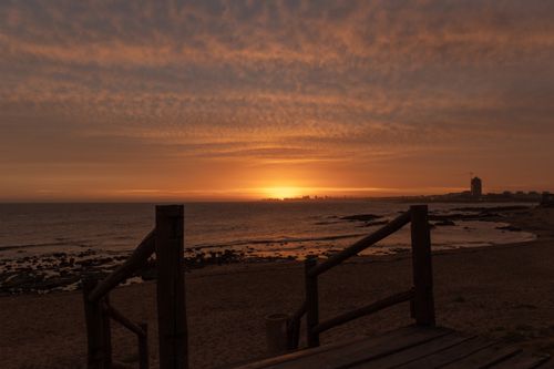 Free Serene beach sunset in La Barra, Uruguay, with vibrant skies and coastal view. Stock Photo