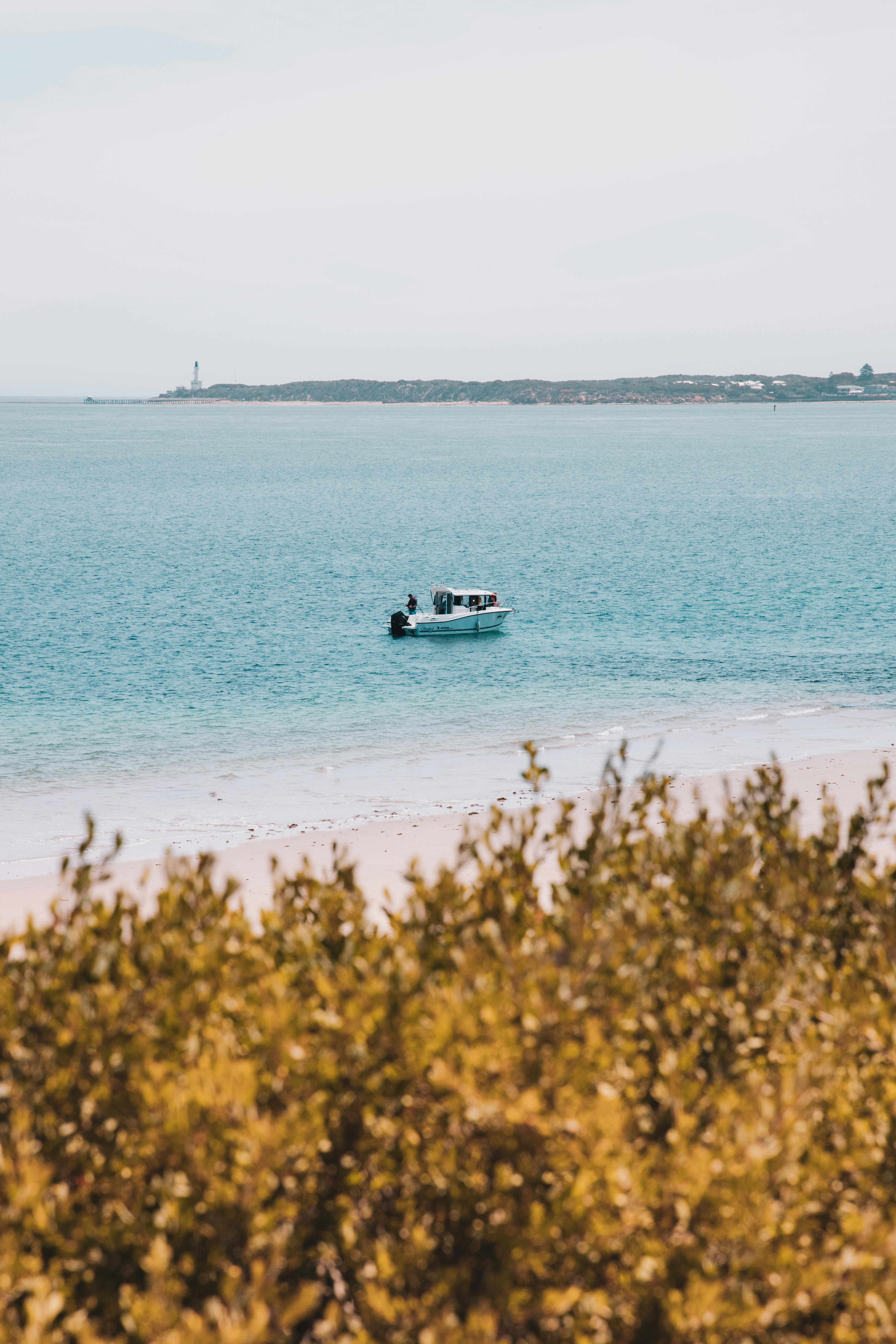 Free A lone boat floats on calm ocean waters near Point Lonsdale, Australia. Stock Photo