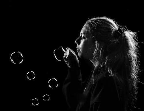 Beautiful Woman Blowing Bubbles 