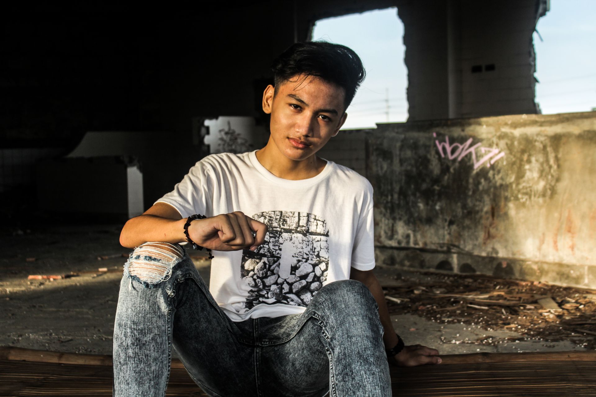 Man in White Crew Neck T-shirt and Gray Acid Washed Jeans