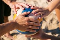 People Holding the Volleyball