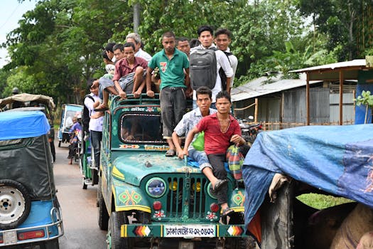 A group of people travel on a crowded jeep in Sajek, highlighting local transportation.