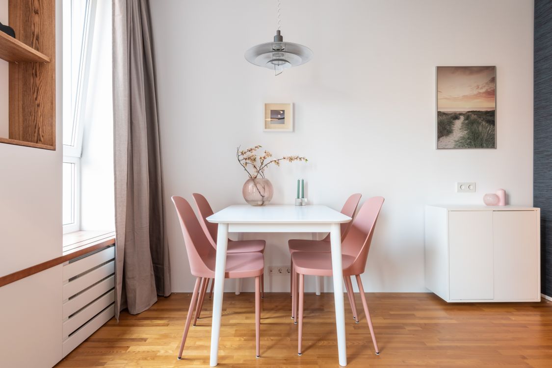 Tiny dining room that feels spacious and welcoming Modern dining room with a wooden table and comfortable chairs
