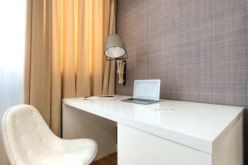 Interior of hotel room with netbook on table