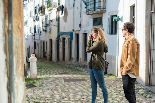 Man and Woman Standing on the Street