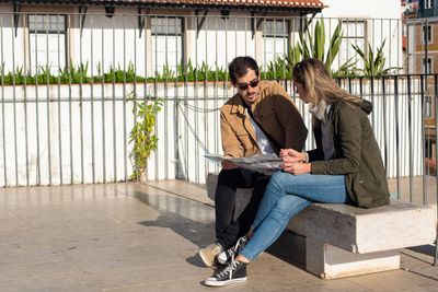 Two people relaxing outdoors with a book — Kampus Production on Pexels