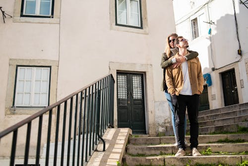 Free A Couple Standing on the Stairs Stock Photo