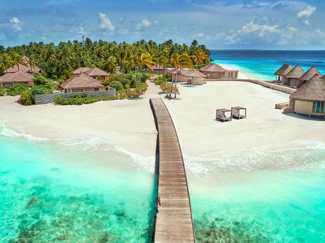 A breathtaking aerial view of a tropical resort with turquoise water and white sandy beaches.