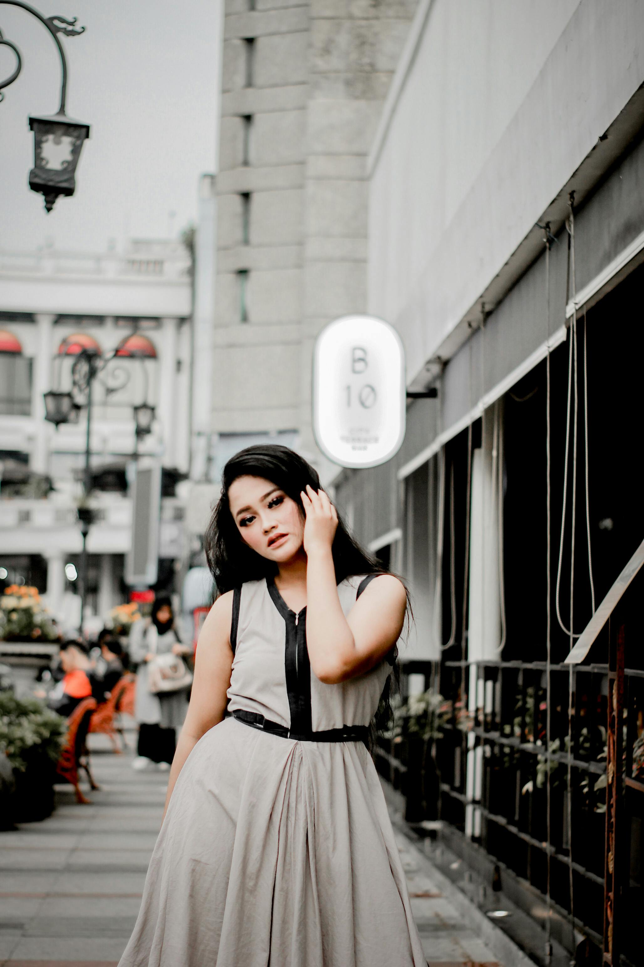 Fashionable woman look with black and white striped suit jacket, leather  pants, posing at old street. Concept of fashion girl. 6750760 Stock Photo  at Vecteezy