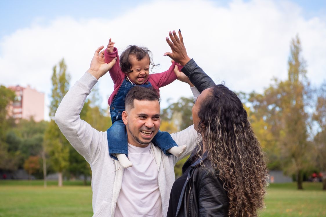 A happy family interacting outdoors in natural daylight