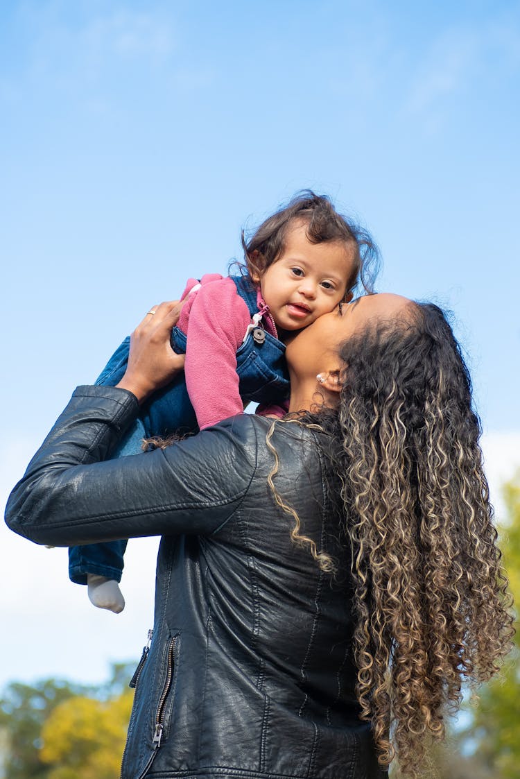 A Woman Kissing Her Child 