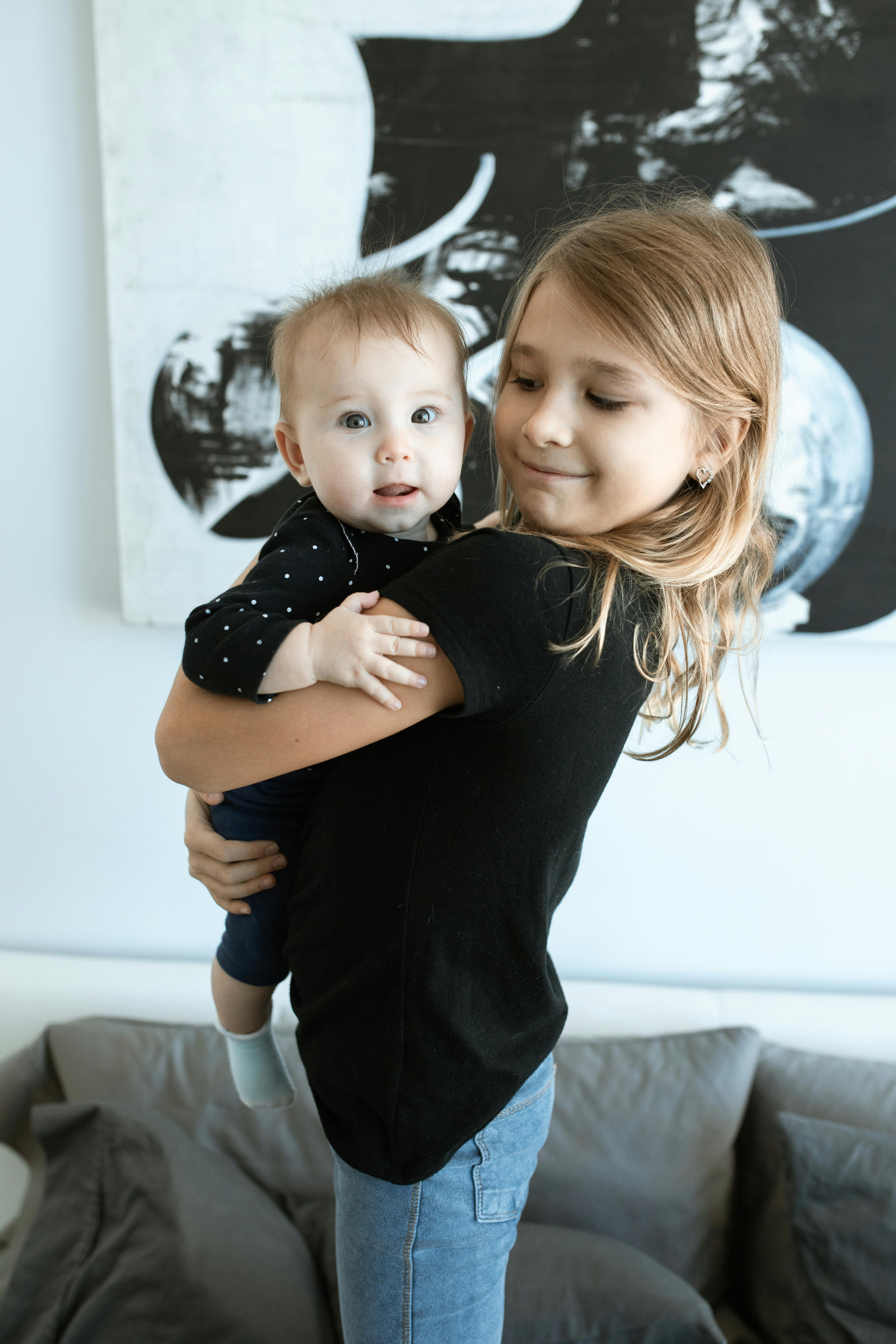 smiling girl carrying a baby